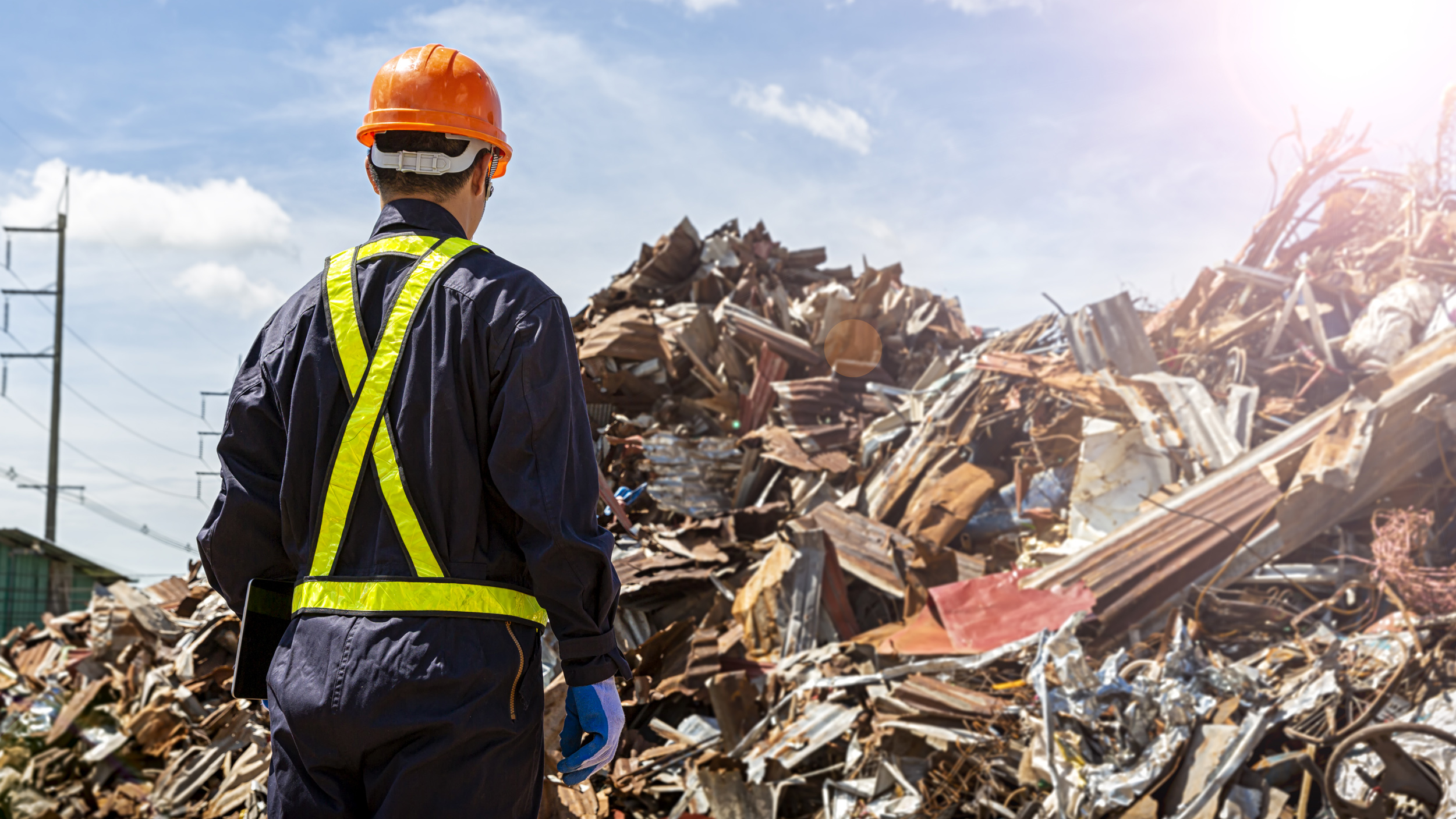 A worker looking at a pile of construction debris