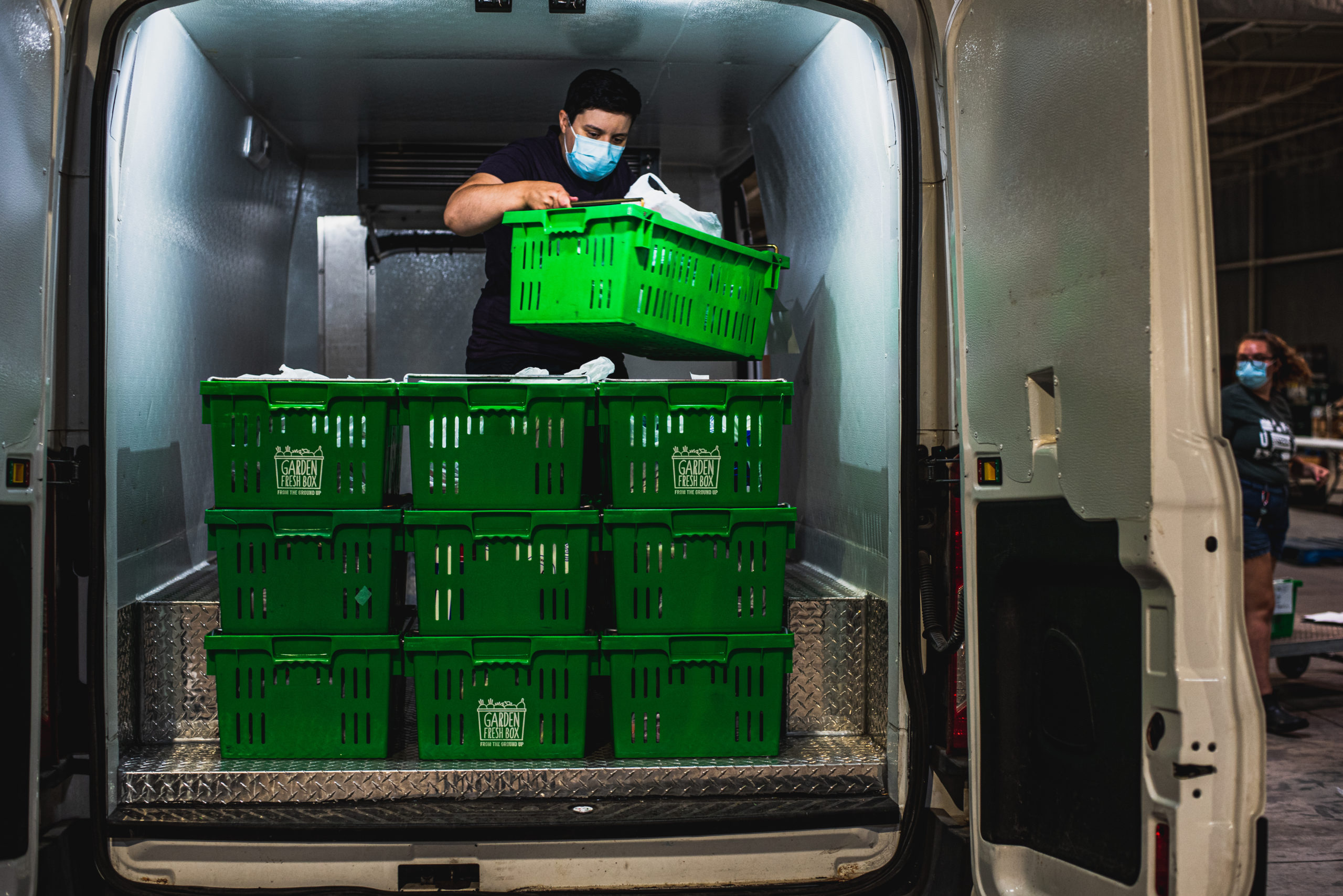Staff from the SEED loading grocery deliveries into a delivery truck