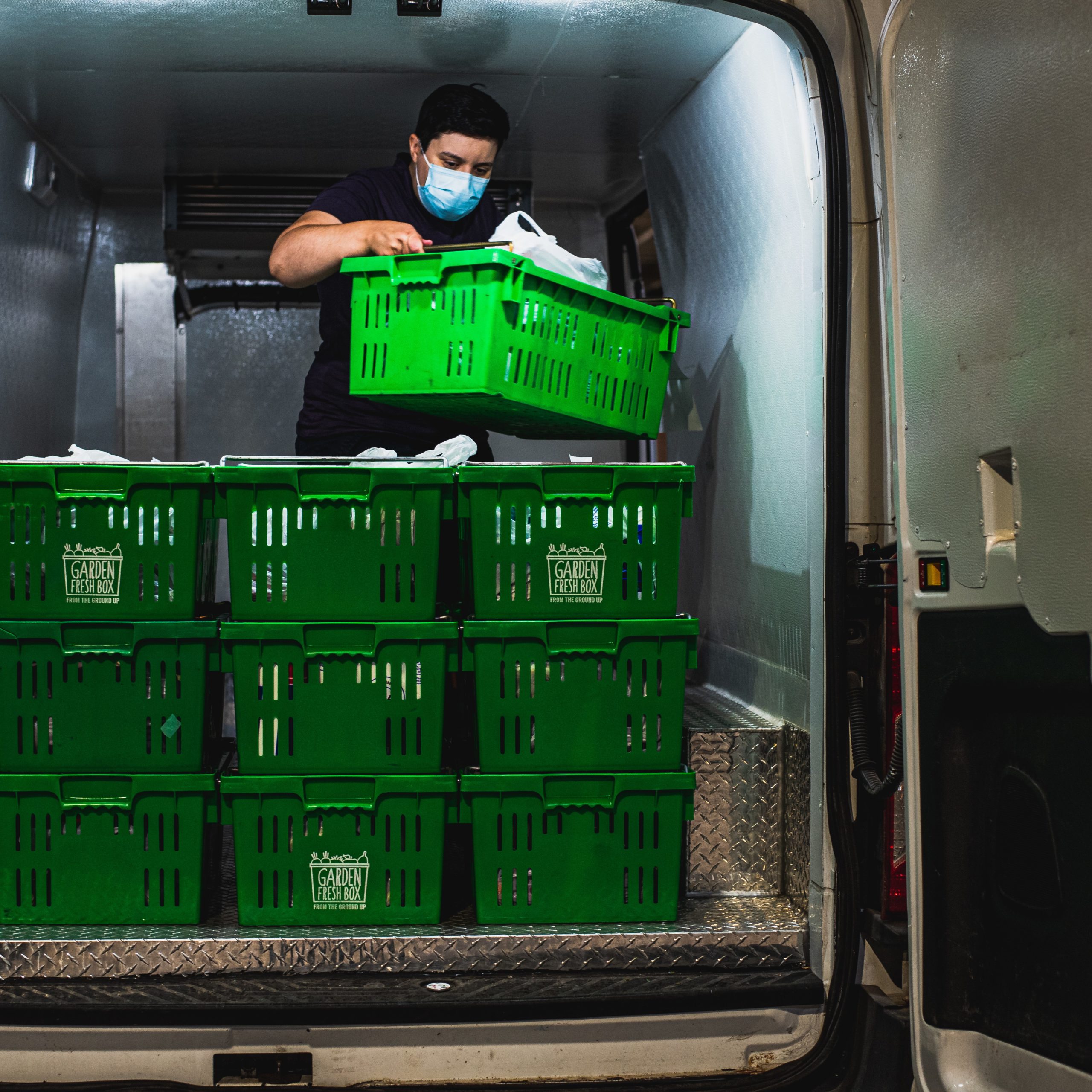 The SEED loading a van for a grocery delivery