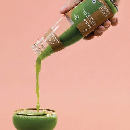 green juice being poured into a glass