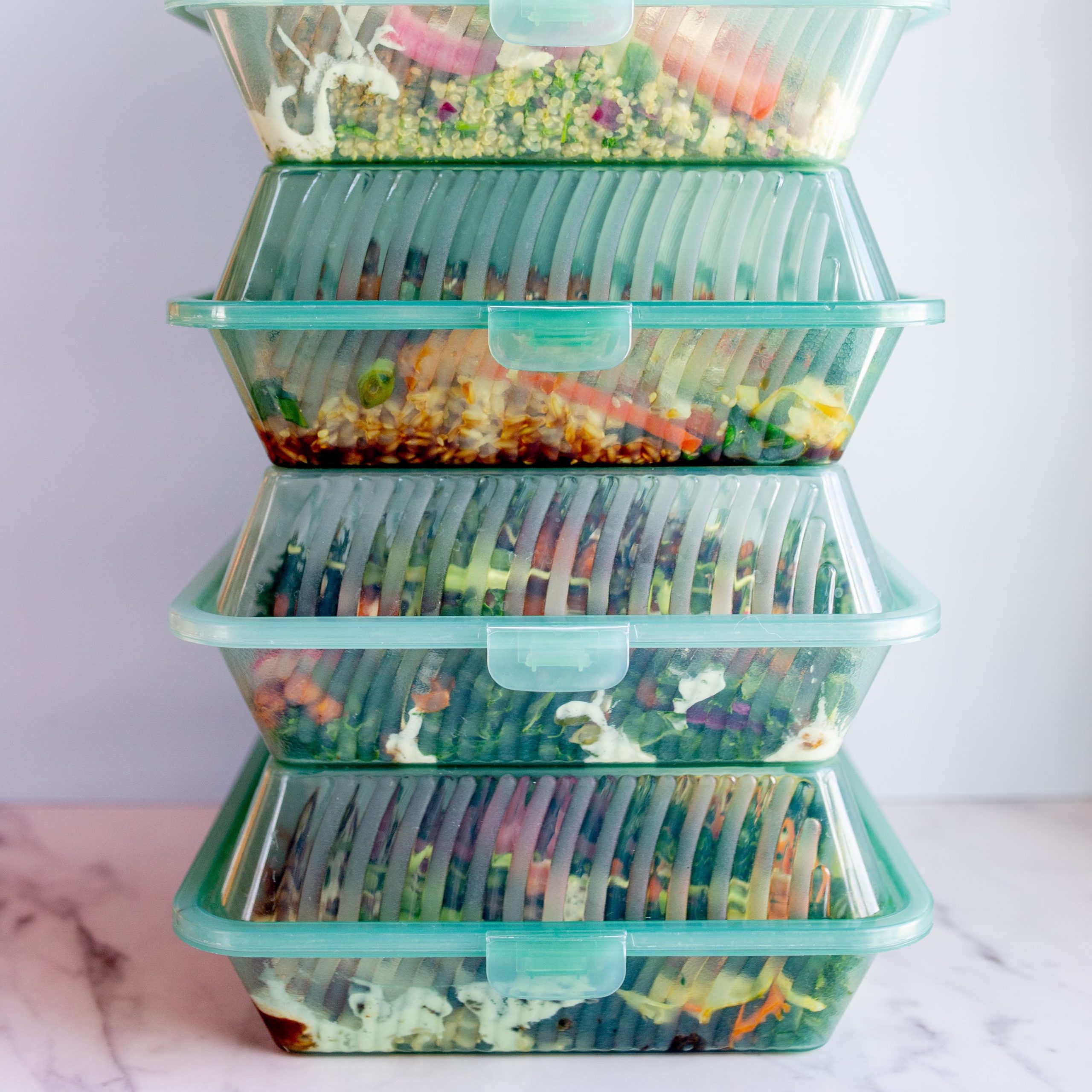 prepared meals in reusable containers stacked on top of each