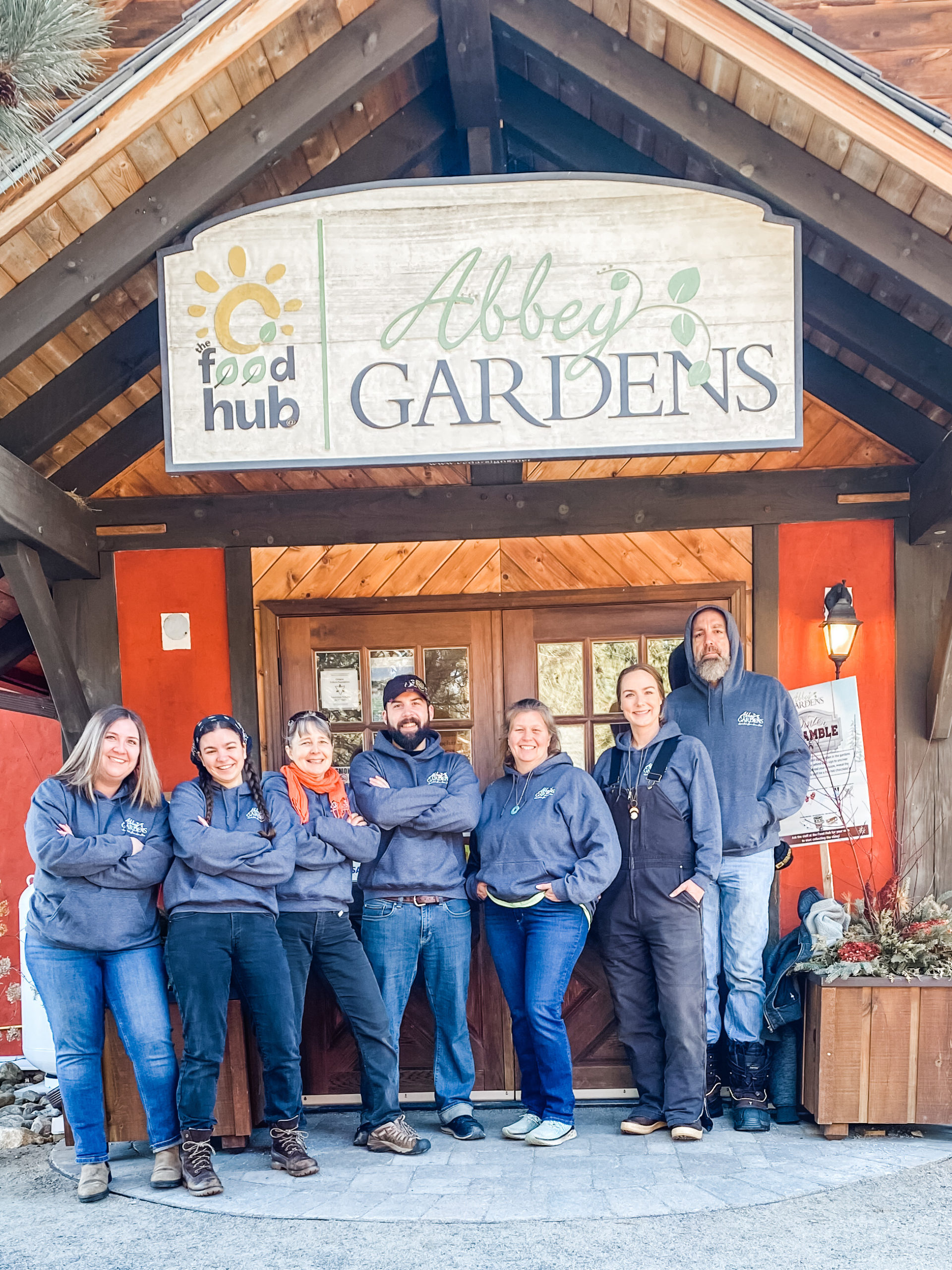 abbey gardens' team standing in front of their sign